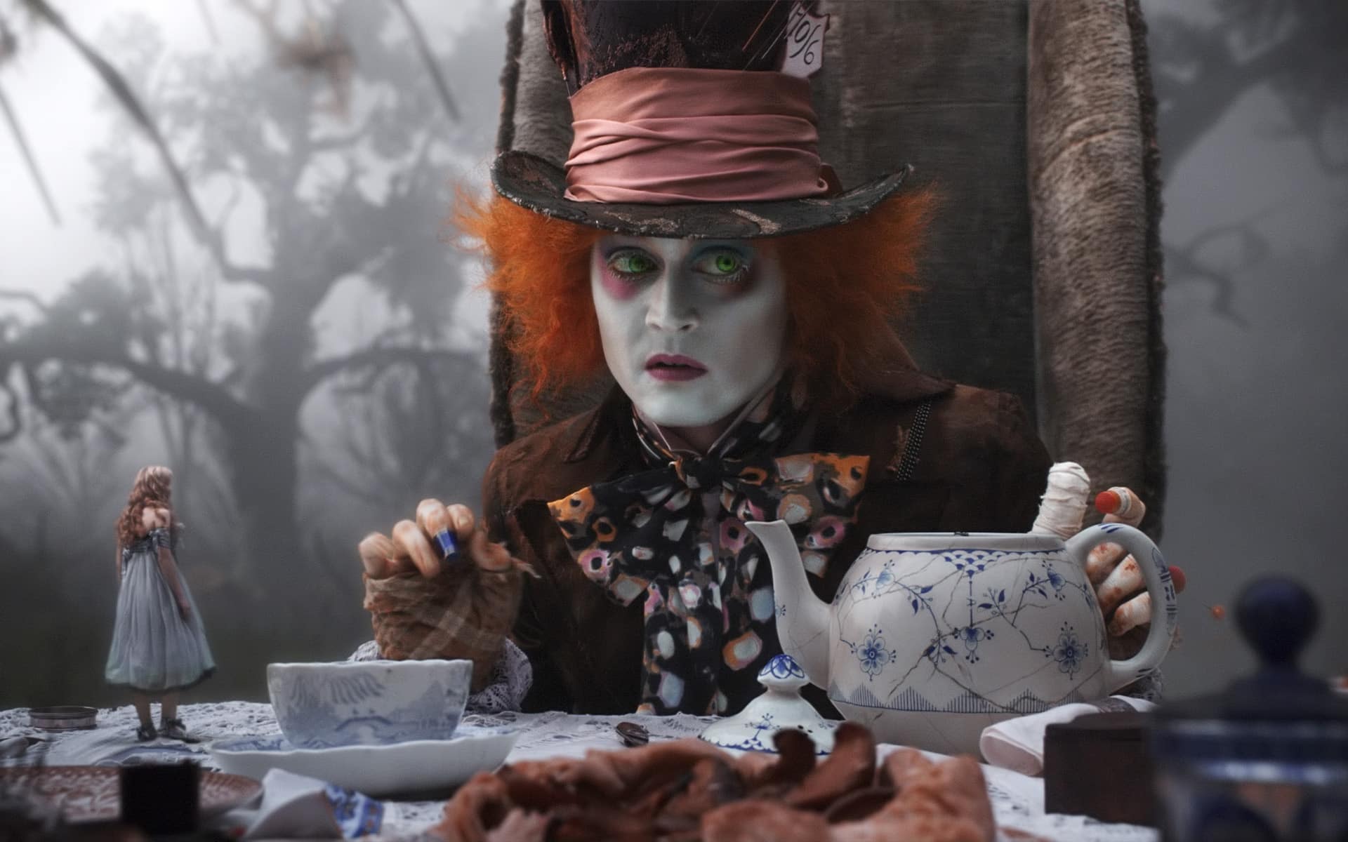 Johnny Depp as the Mad Hatter hosting a tea party in Disney's live-action Alice in Wonderland.
