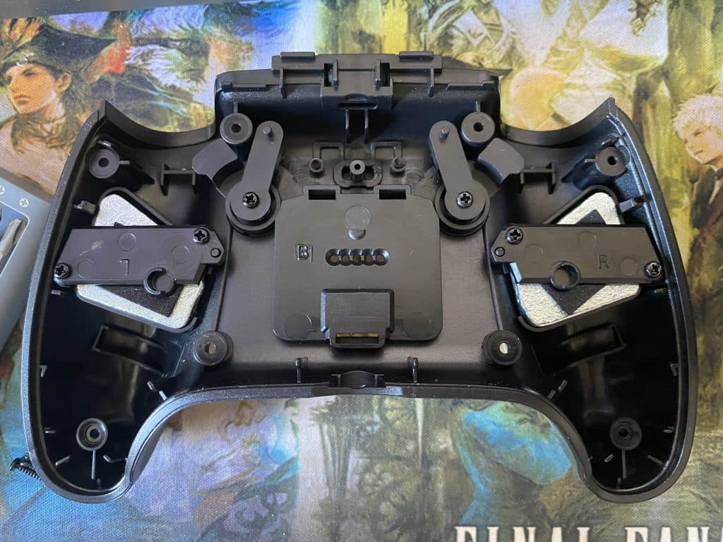 The insides of the PowerA Fusion Pro 2 controller, showing two weights inside.