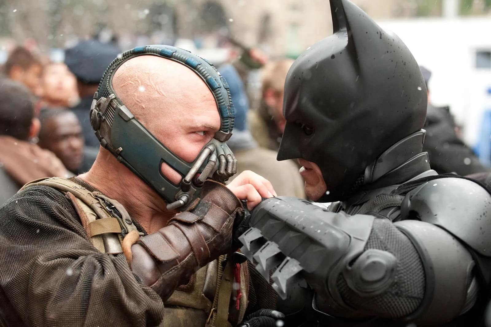 Christian Bale's Batman and Tom Hardy's Bane locking arms in DC's The Dark Knight Rises.