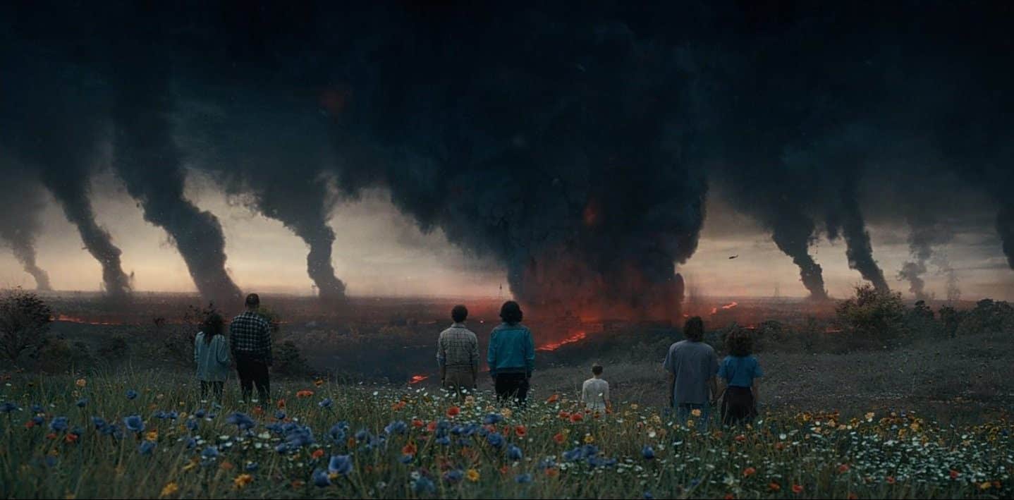 Explosions and smoke in Hawkins in front of the Stranger Things cast in the Season 4 finale