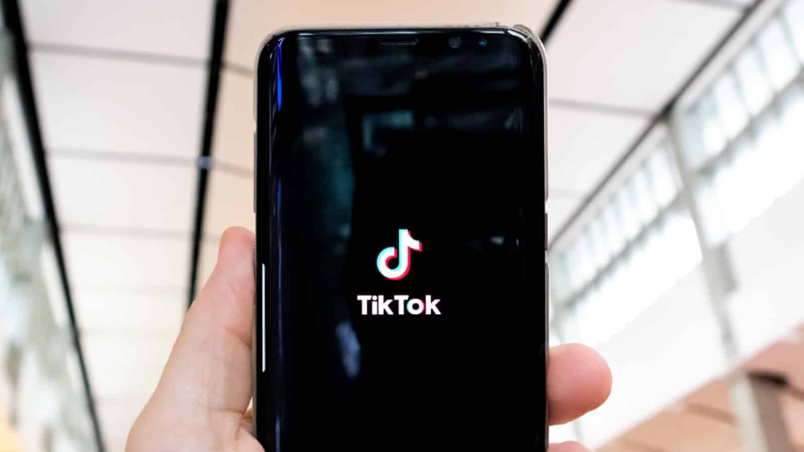 TikTok logo on a black phone screen