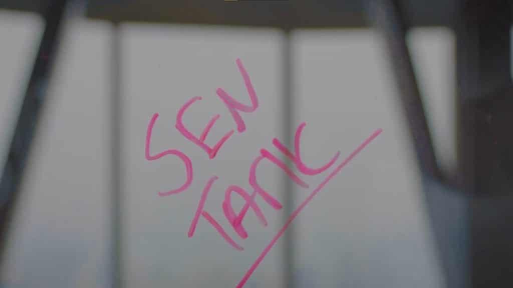 SEN TARIK written in dry erase marker on glass