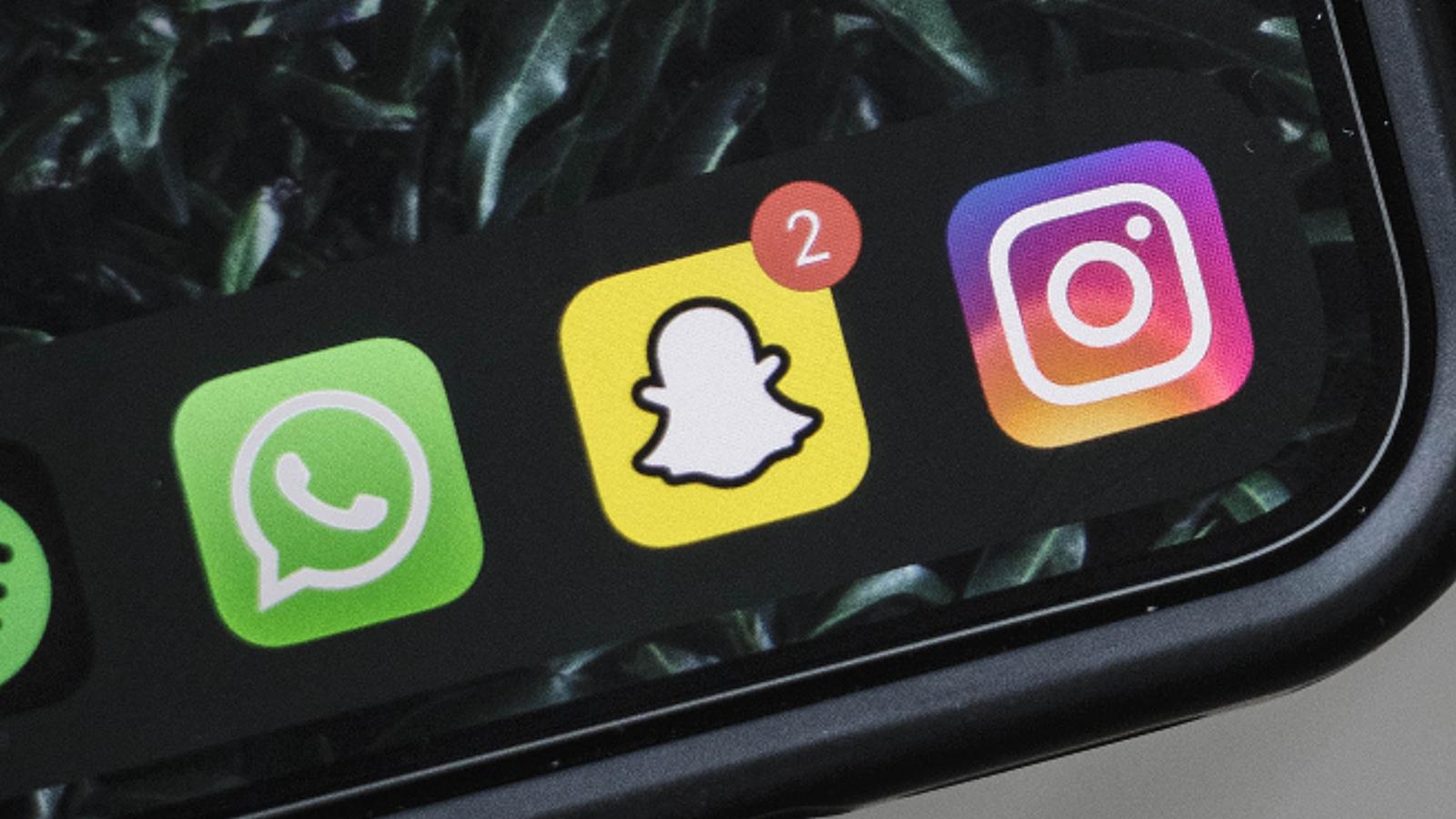 Snapchat, Instagram, and WhatsApp logo on phone