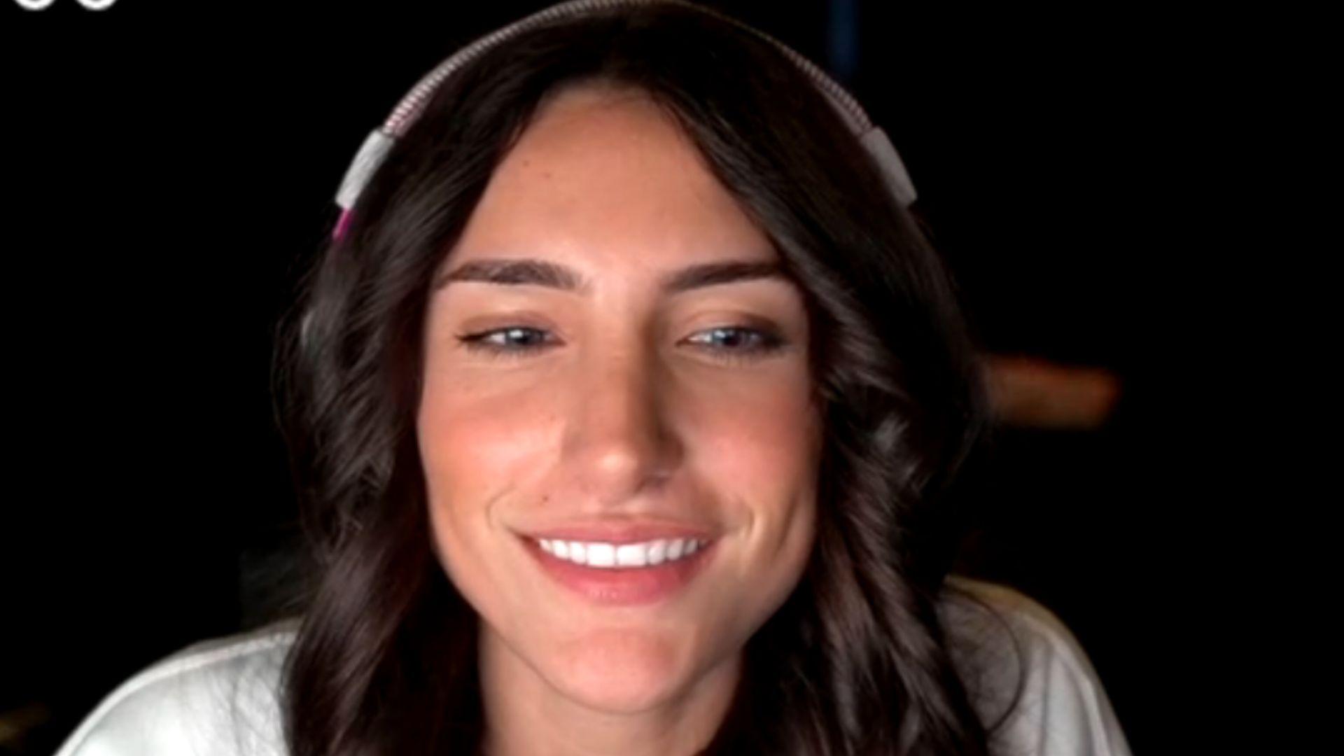 Nadia smiling on stream in white shirt