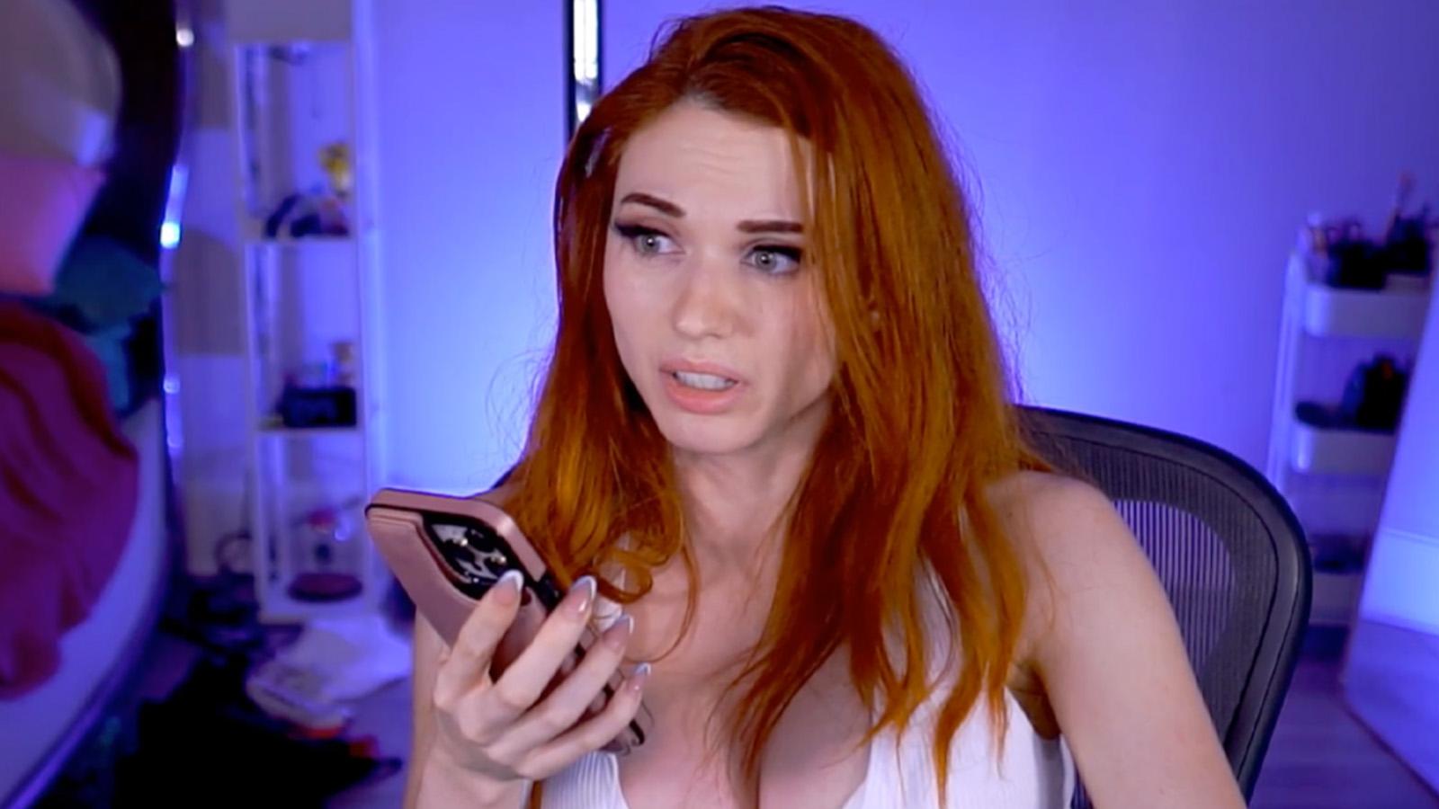 Amouranth speaking into phone on stream