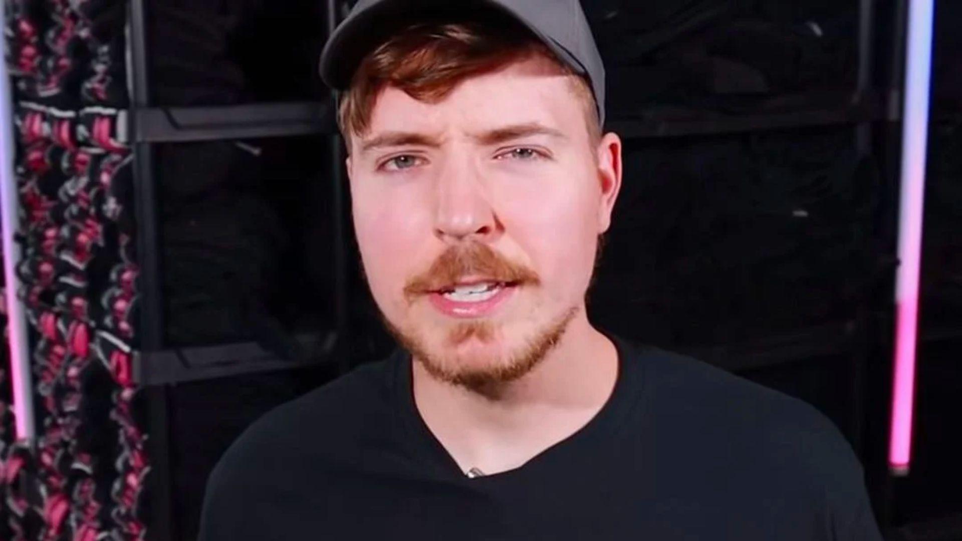 MrBeast in black shirt and grey hat looking at camera with one eye closed