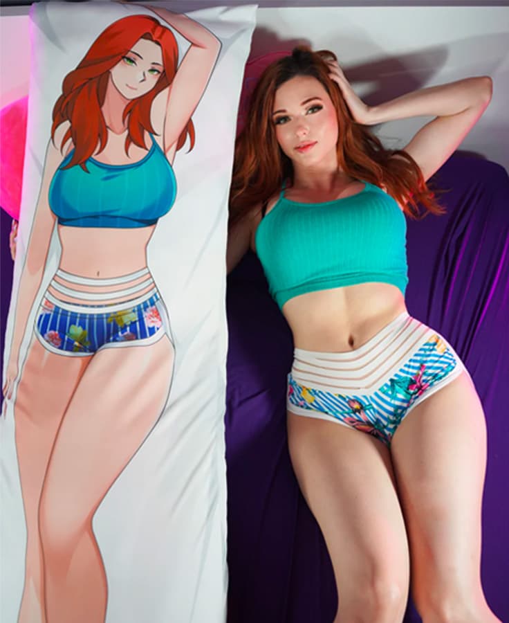 Amouranth lying next to her body pillow