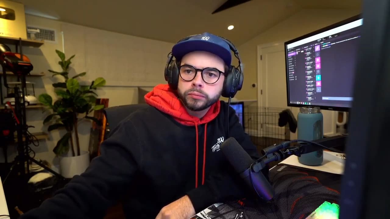 Nadeshot wearing 100 Thieves hoodie at desk
