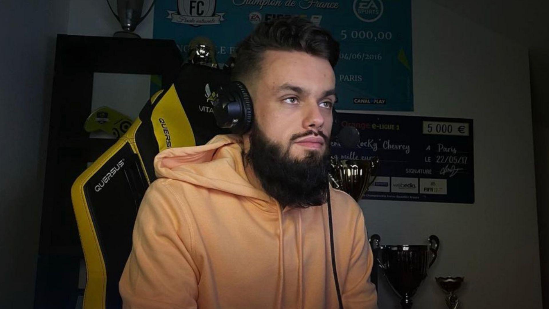 FIFA pro RocKy sat at desk with headphones on in light hoodie