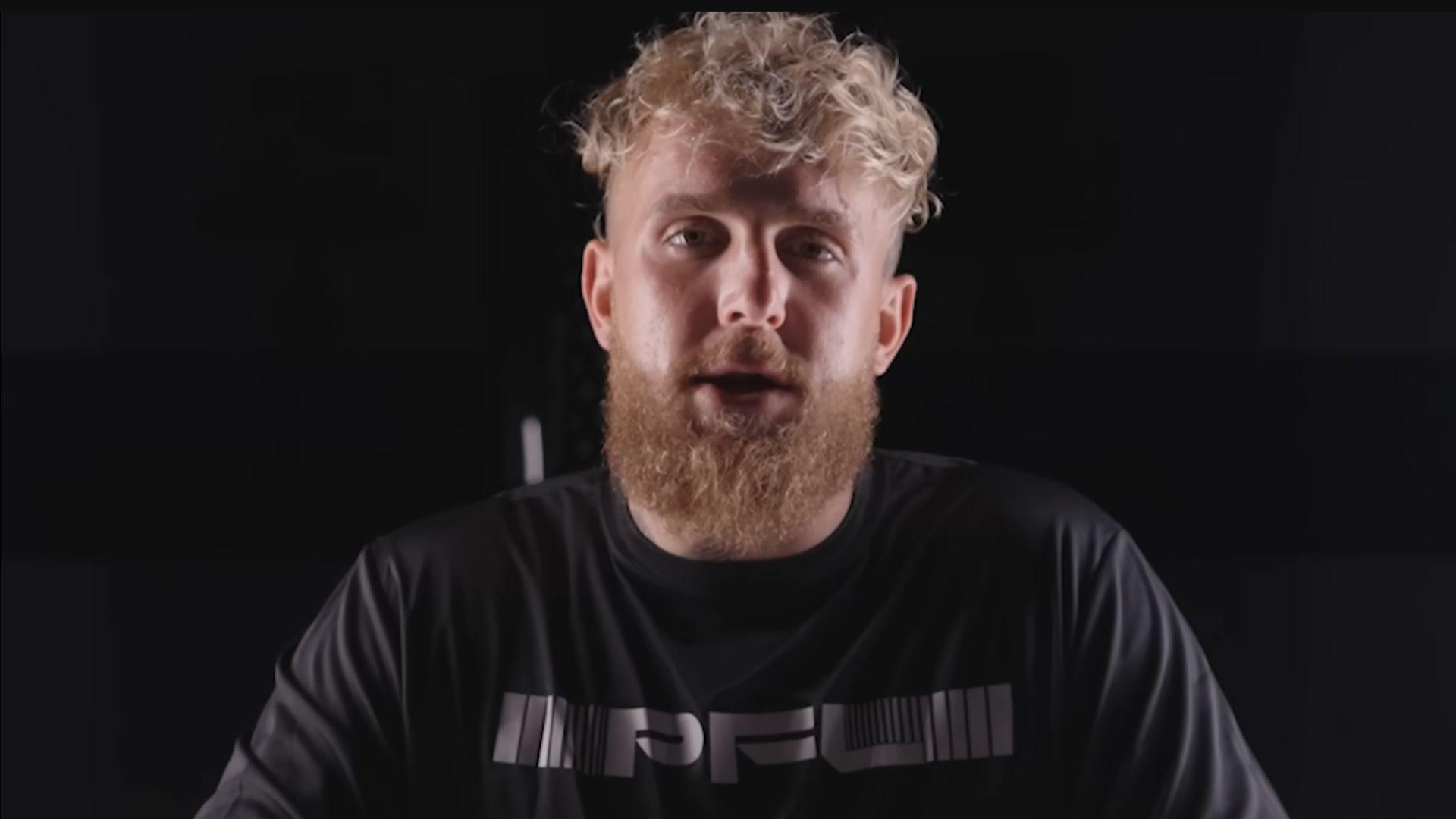 Jake Paul in black shirt with PFL on against black background