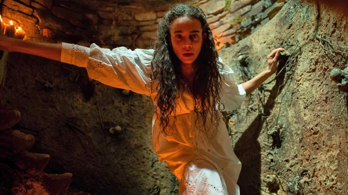Hannah-John Kamen heads into a cave in Unwelcome.