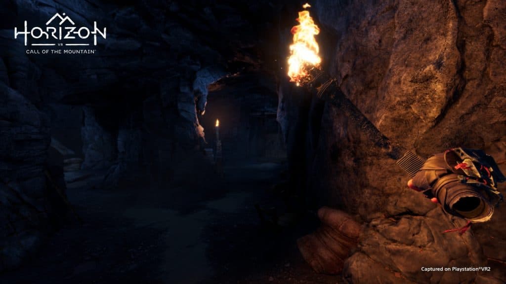 Exxploring a dark cave with a torch in Horizon Call of the Mountain