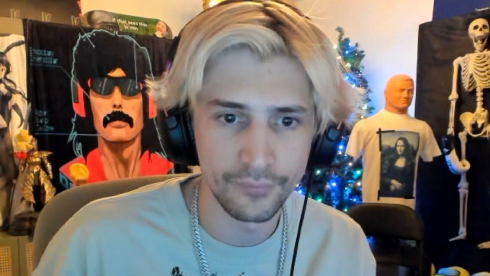 xQc in white shirt staring at camera