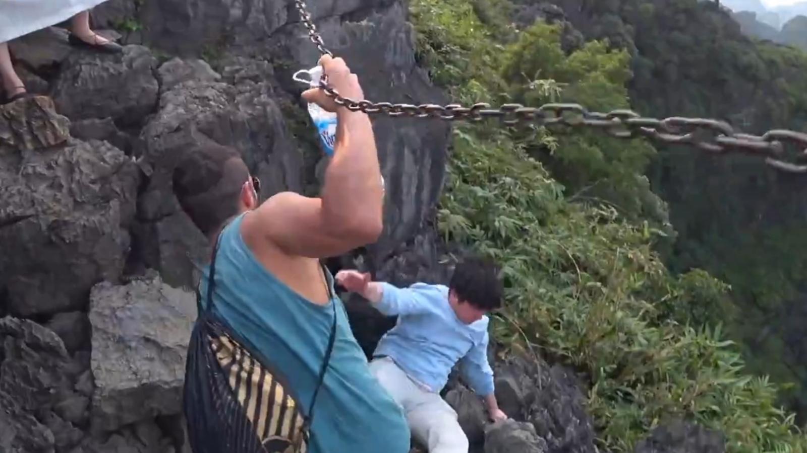 man almost falls off mountain