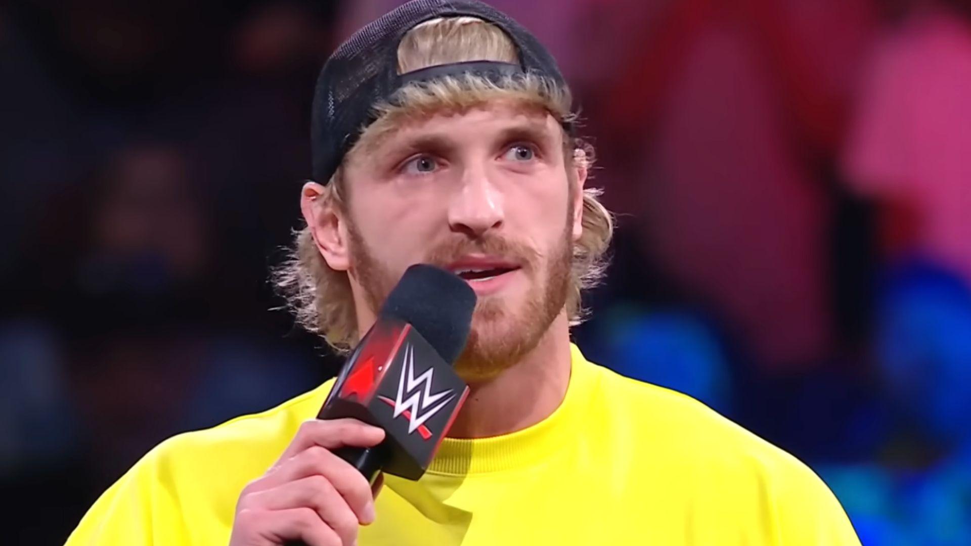 Logan paul in yellow shirt talking into WWE mic