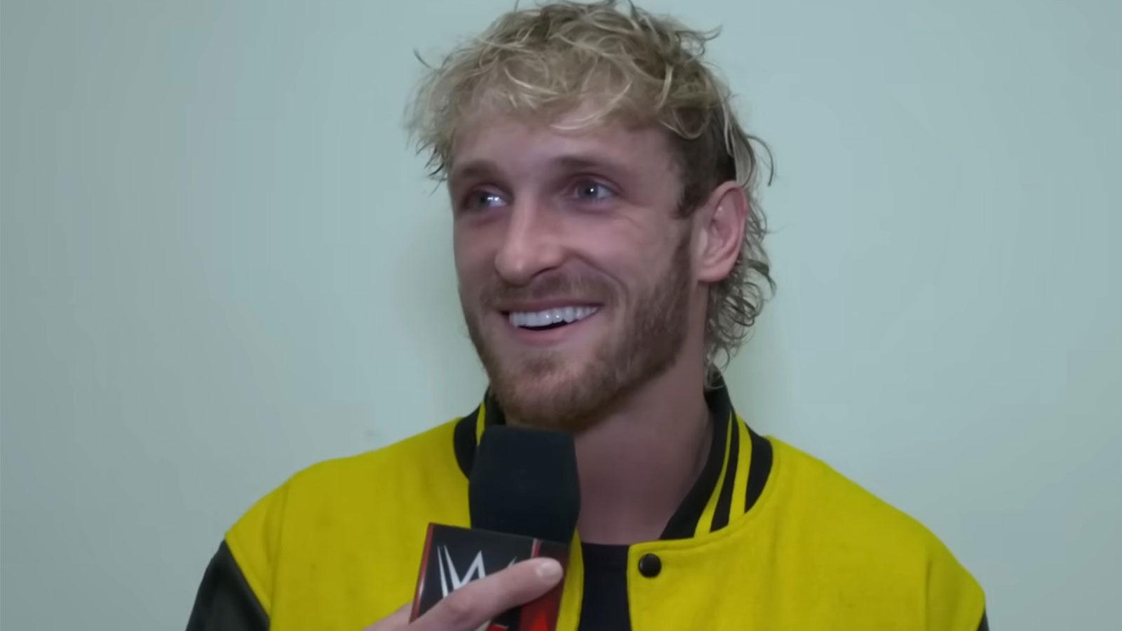 Logan Paul wearing yellow Maverick jacket holding WWE microphone