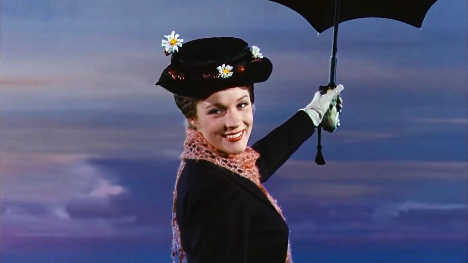Mary Poppins holding her umbrella and smiling