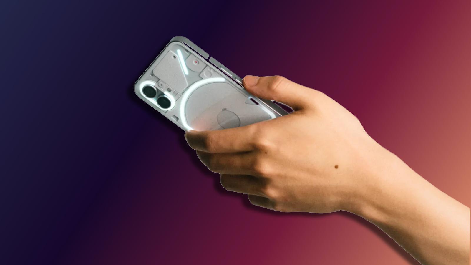 Someone holding the White Nothing Phone 1 with a gradient background