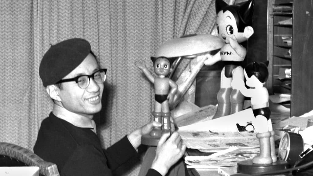 An image of Osamu Tezuka with Astro Boy models