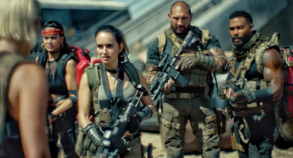 The cast of Army of the Dead hold military weapons