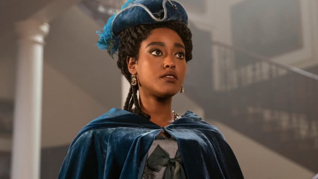 Young Lady Dansbury wears a velvet cape in Queen Charlotte: A Bridgerton Story