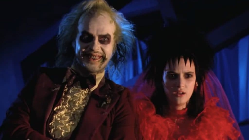 Michael Keaton and Winona Ryder stand side by side in Beetlejuice