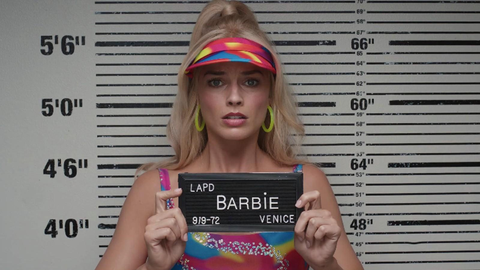 Barbie poses for her mugshot in the Barbie movie