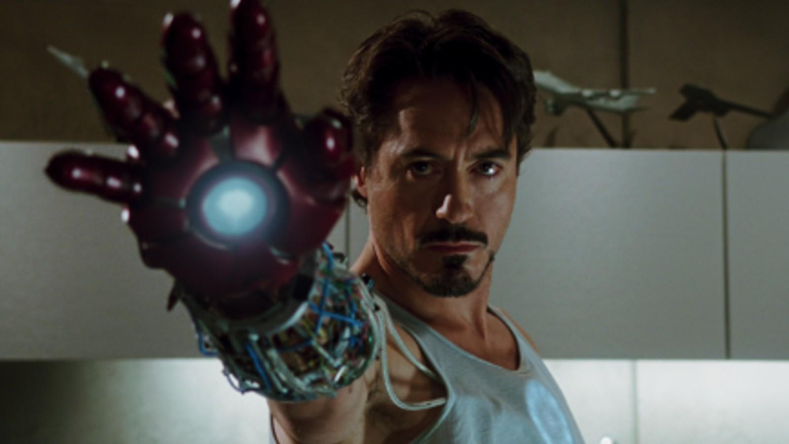 A close up of Tony Stark holding up one of his suit gauntlets in Iron Man
