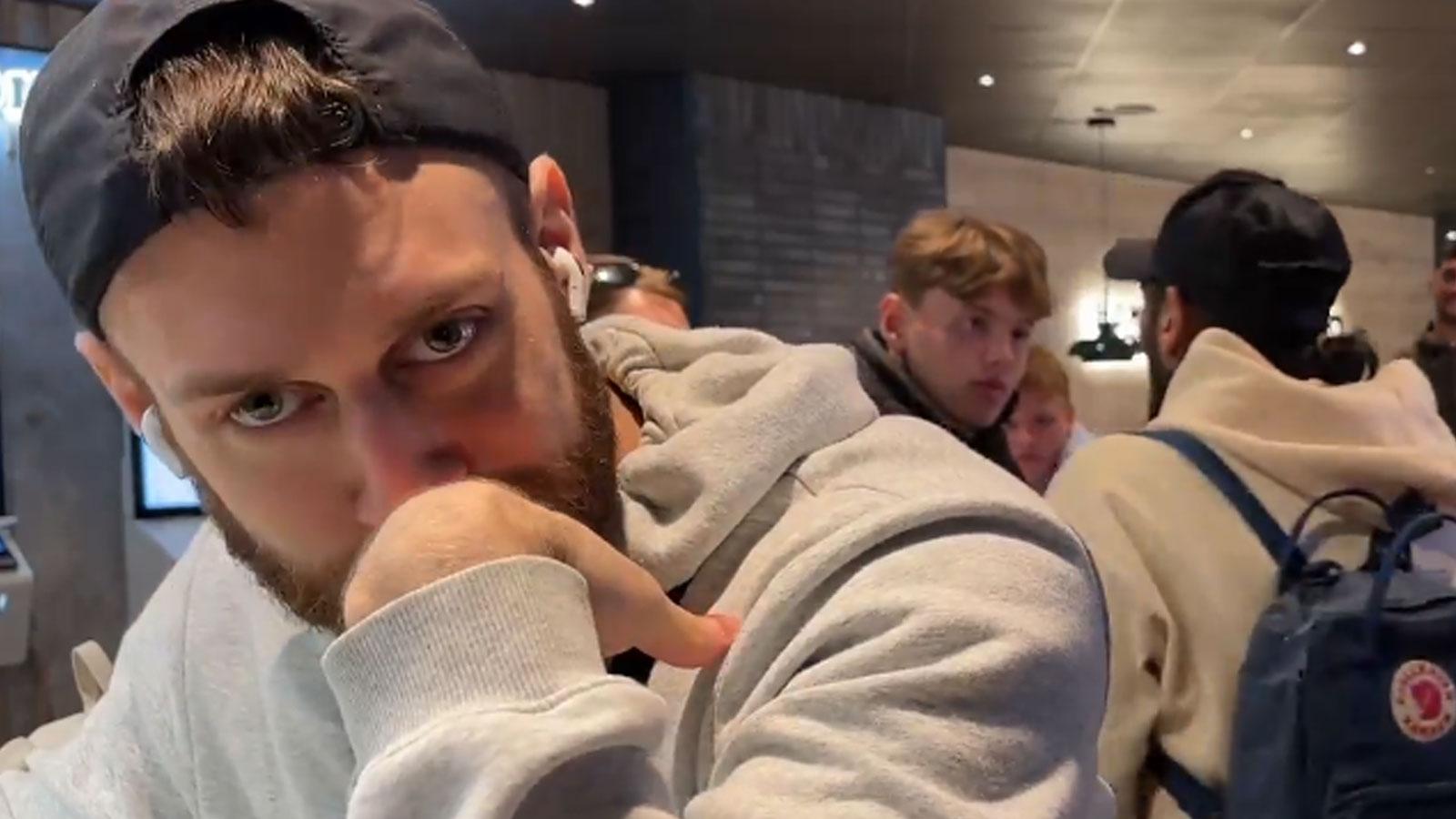 Twitch streamer gfysik with two men stood behind him in Burger King