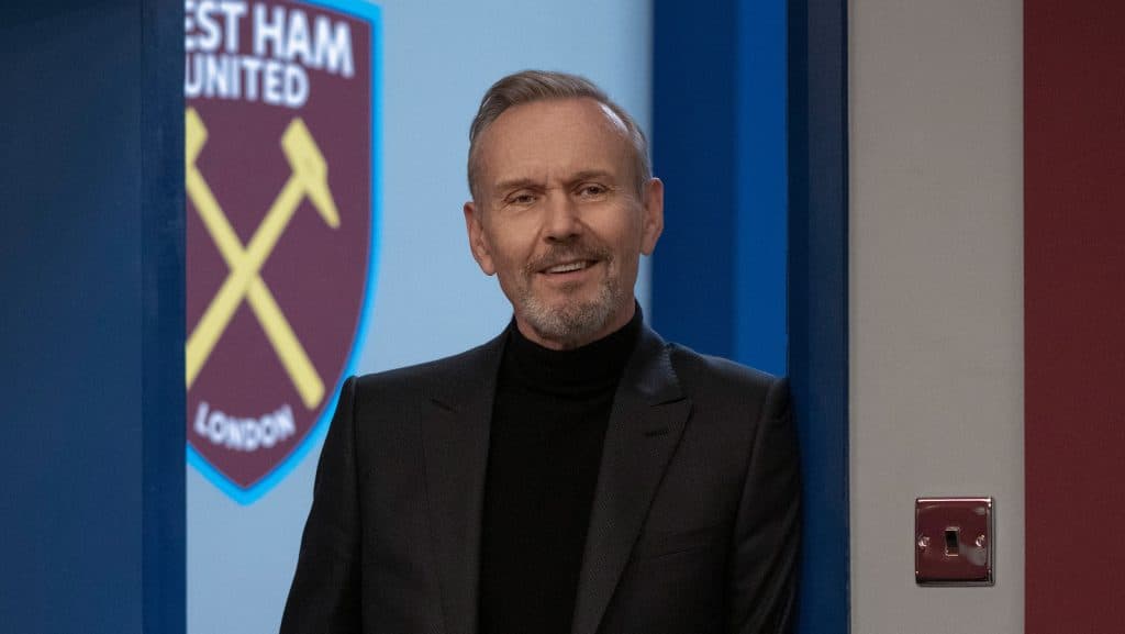 Rupert in front of the West Ham logo in Ted Lasso
