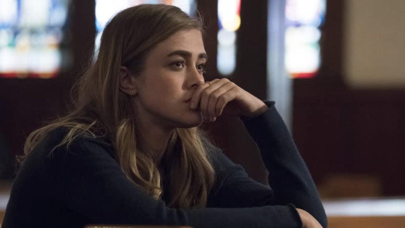 Michaela Stone sits in a church in the show Manifest