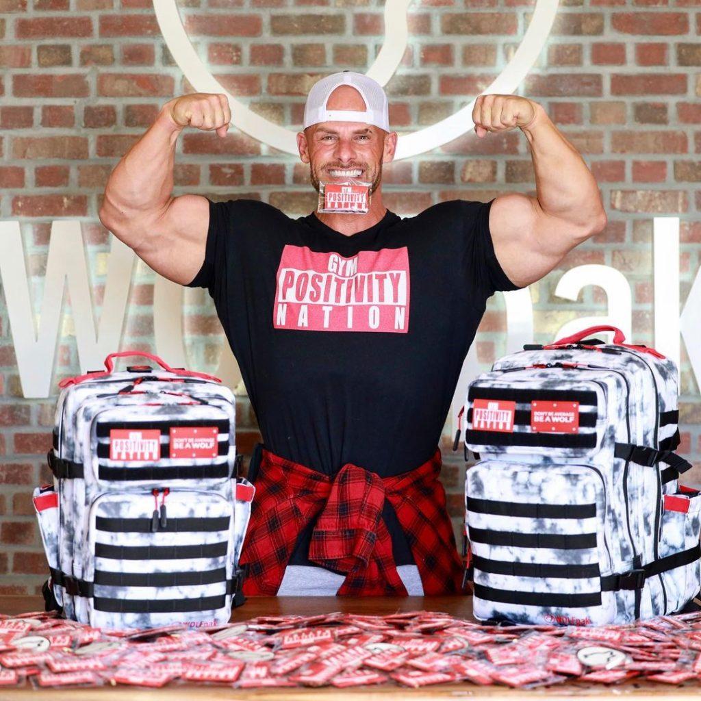 Joey Swoll flexes while promoting his merchandise.