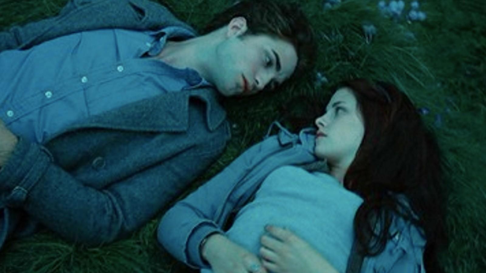 Kristen Stewart and Robert Pattinson lay side by side in Twilight