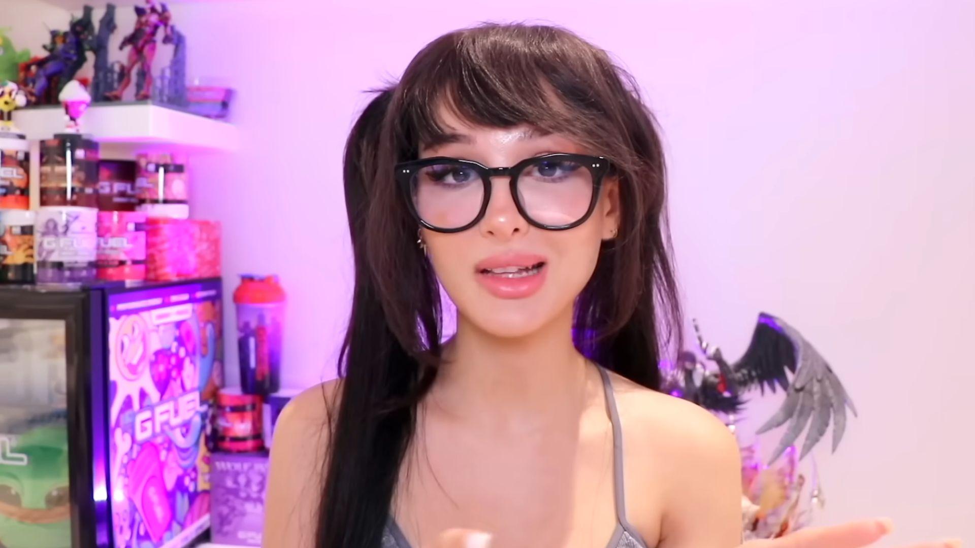 SSSniperwolf talking to camera against pink wall for YouTube video