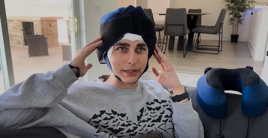 Colby Brock wears a 'cold cap' to help prevent hair loss from cancer.