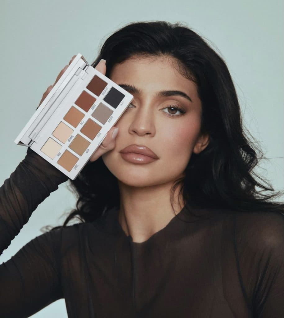 Kylie Jenner posing with her Kylie Cosmetics product.