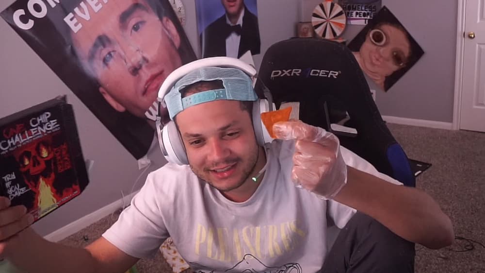 Erobb holding a hot chip and One Chip Challange box during his livestream