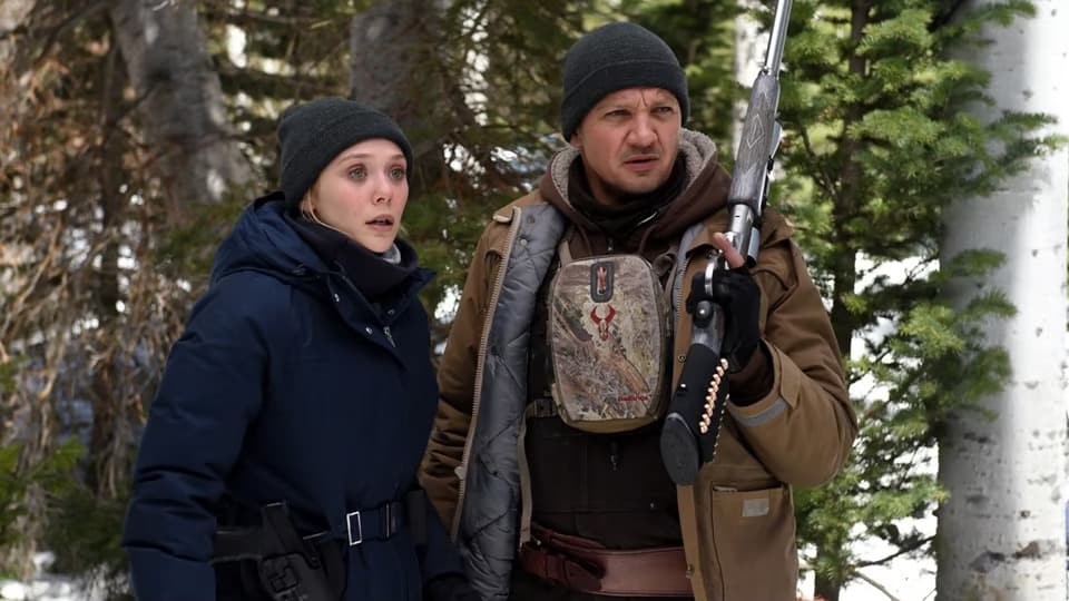Elizabeth Olsen and Jeremy Renner in Wind River, one of Taylor Sheridan's movies