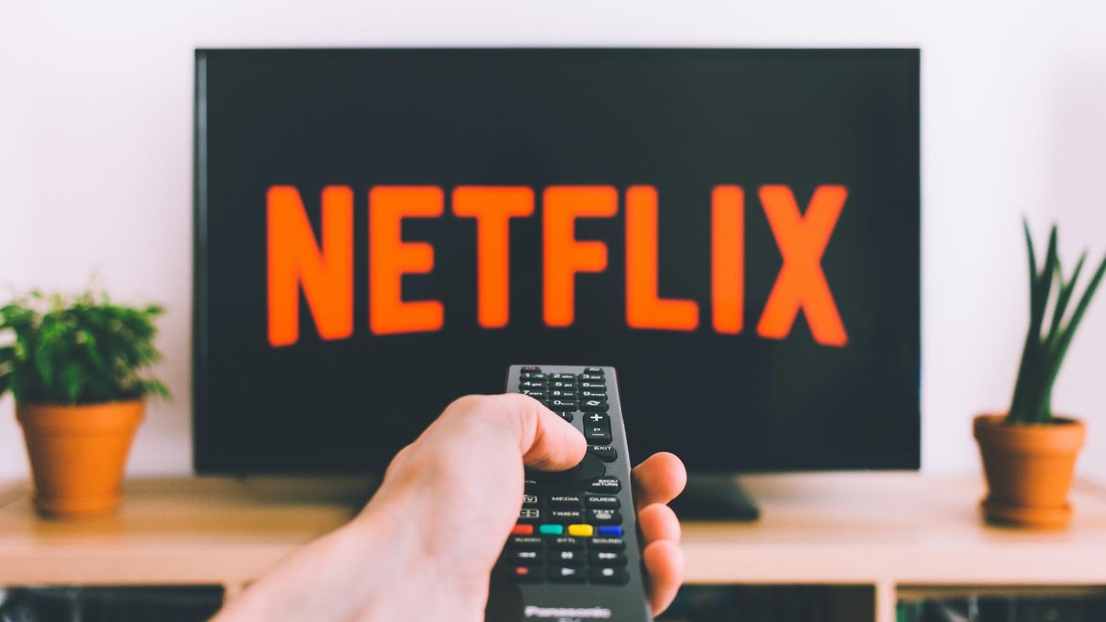 A person pointing their remote at a Netflix screen