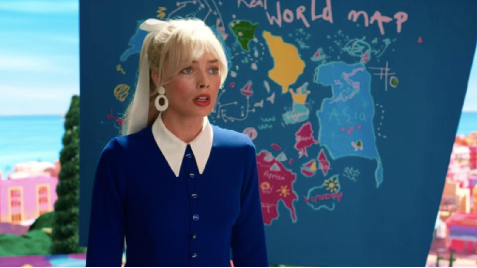 Barbie stands in front of a world map