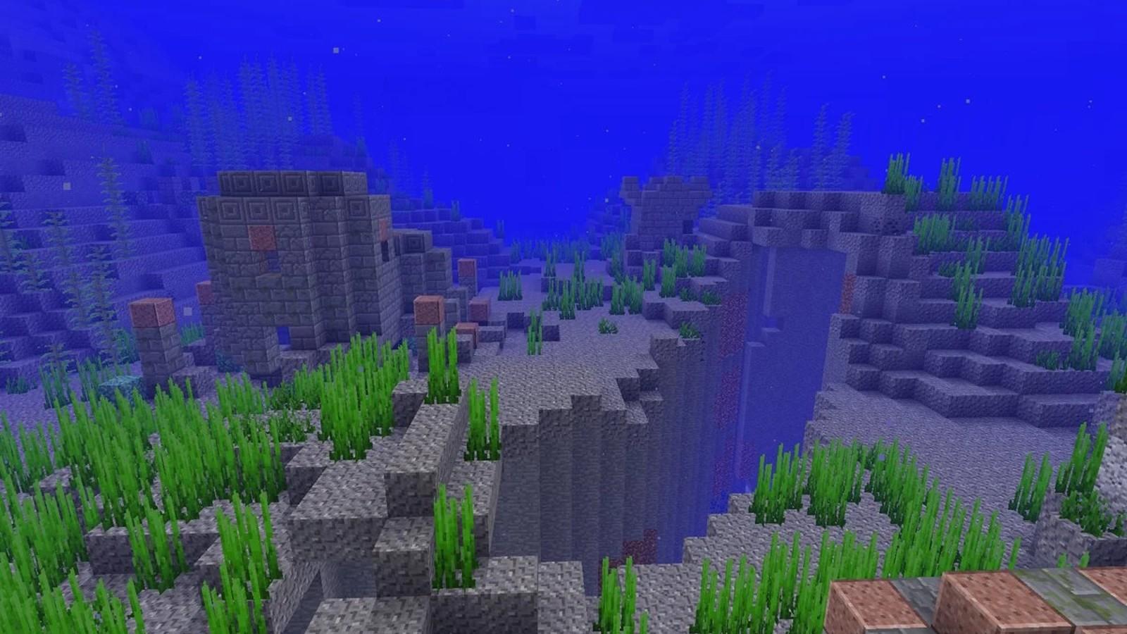 An image of underwater ruins in Minecraft where players can use the respiration enchantment.