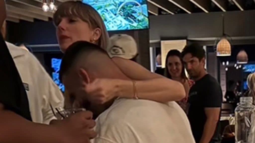 Taylor Swift with her arm around Travis Kelce after the Chiefs game last Sunday.