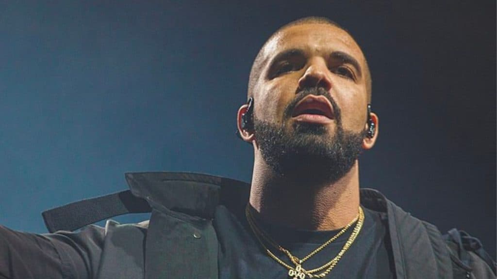 Drake in black jacket performing at concert