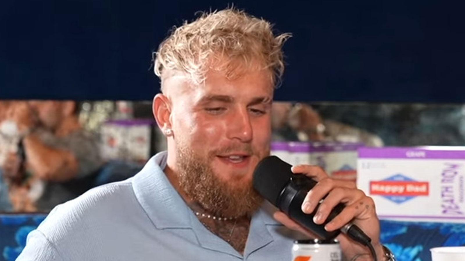 Jake Paul sat holding a microphone for FULL SEND podcast