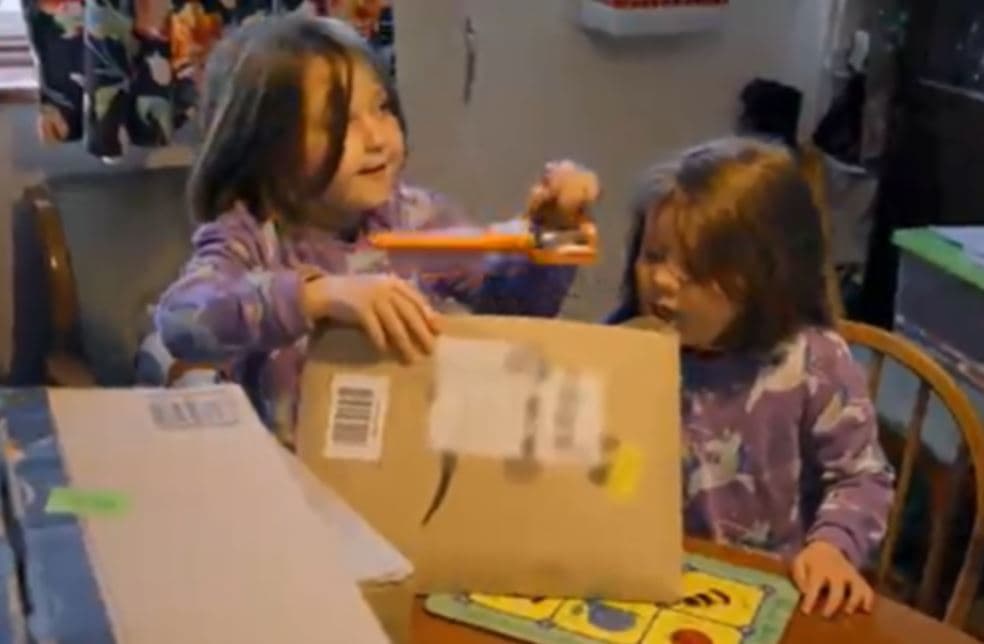two girls opening items from Amazon