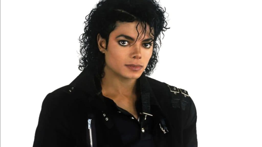 Michael Jackson standing in front of a white background.