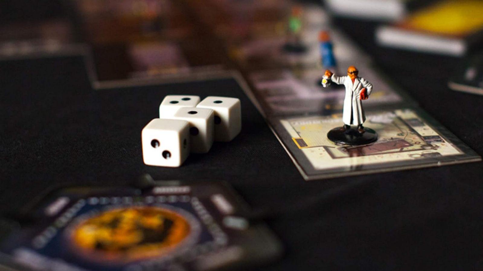 Best Halloween board games header - piece, dice and card