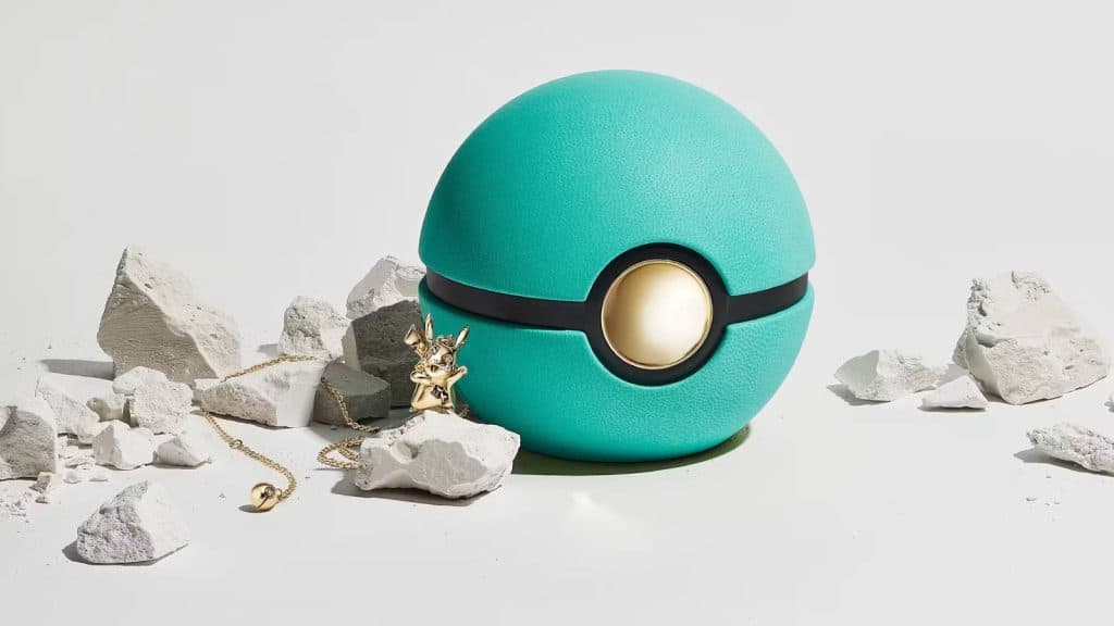 A diamond Tiffany and Co. Pikachu necklace sits next to a green Poke Ball