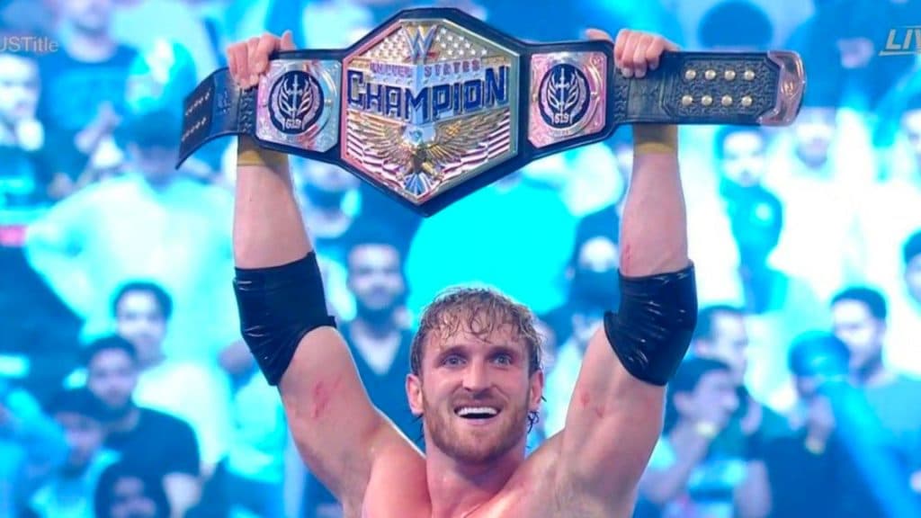 Logan paul holding wwe united states championship above his head