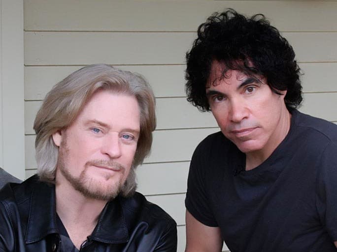 Daryl Hall and John Oates sitting and looking into the camera